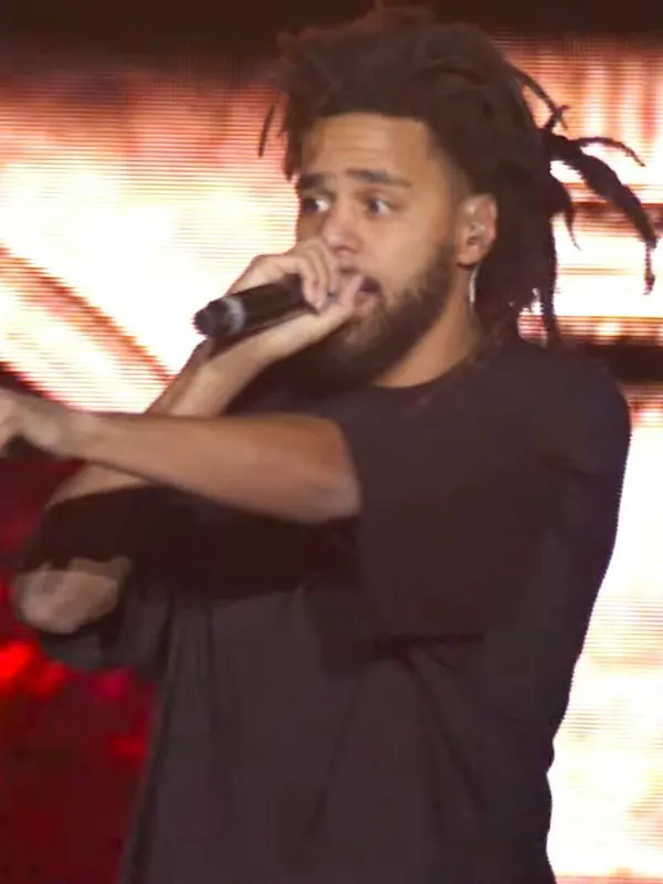 J. Cole performing on stage